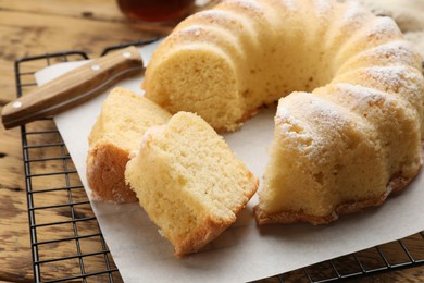 Photo of Delicious freshly baked sponge cake on wooden table, closeup