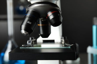 Modern microscope with different lenses in laboratory, closeup. Medical equipment