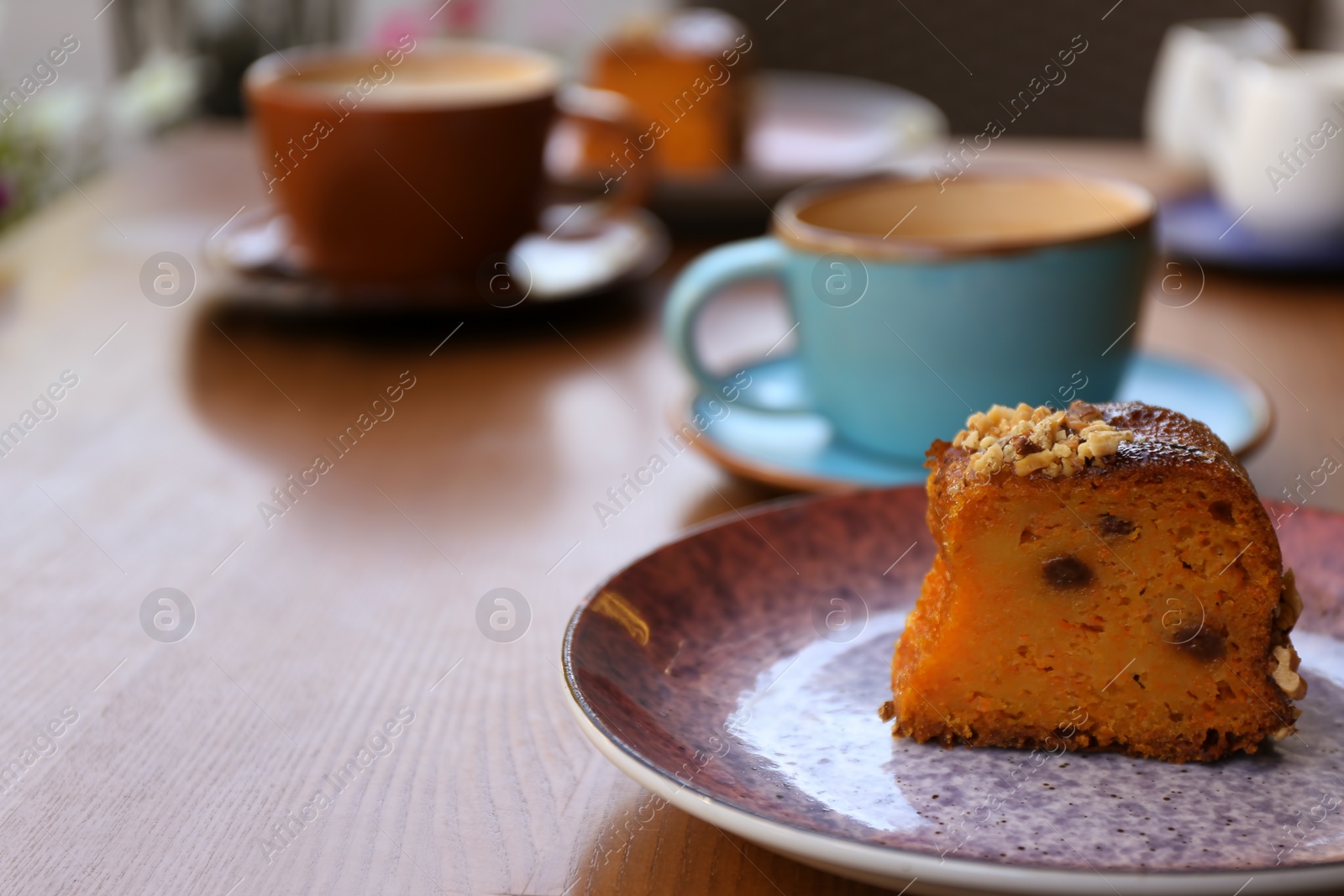 Photo of Plate with slice of carrot cake on wooden table