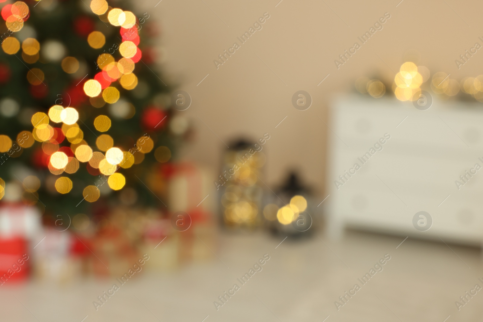 Photo of Beautiful tree decorated for Christmas and gift boxes indoors, blurred view. Interior design