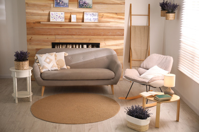 Photo of Stylish sofa and rocking chair in beautiful living room interior