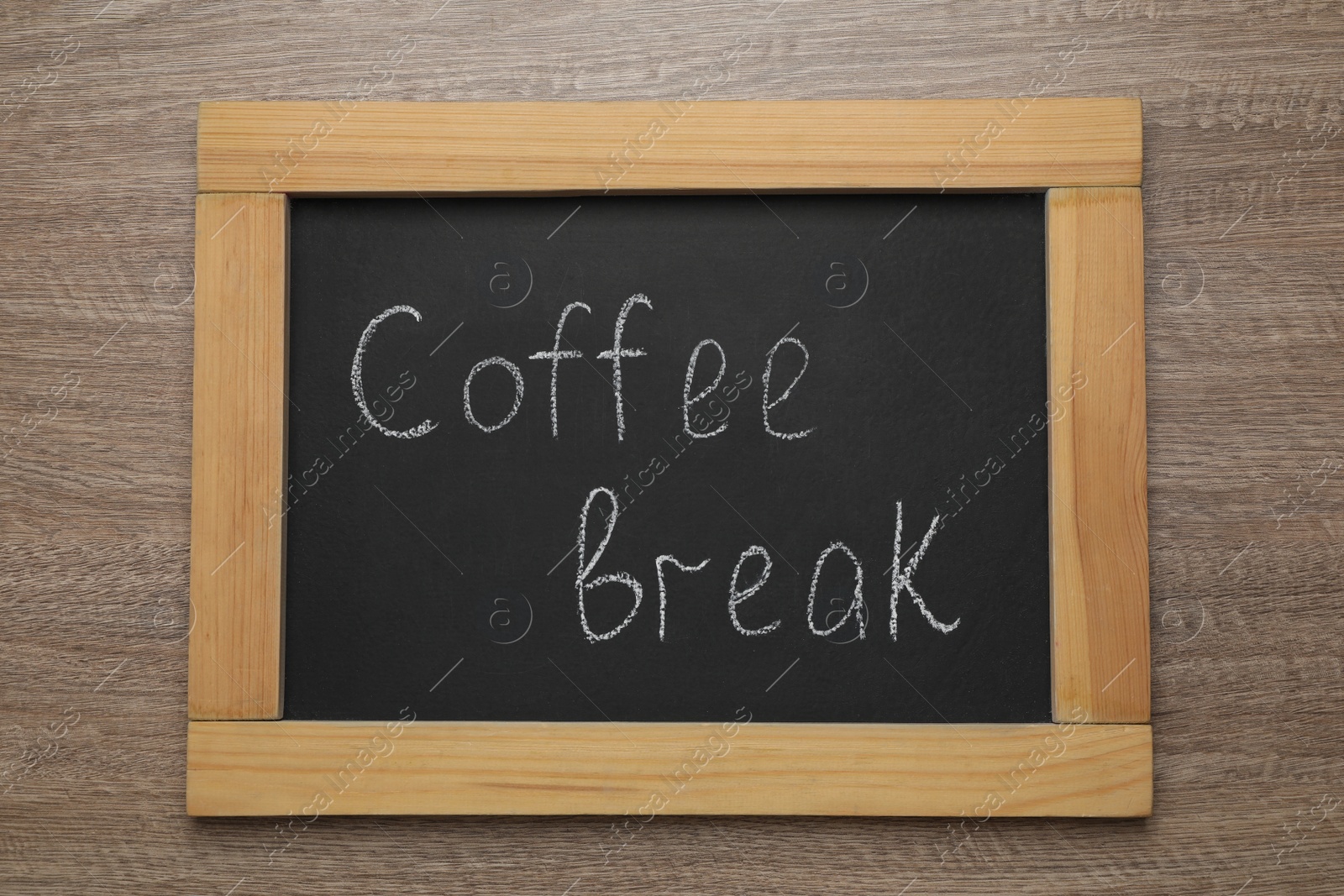 Photo of Blackboard with phrase Coffee Break on wooden table, top view
