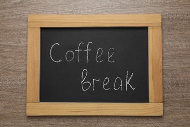 Photo of Blackboard with phrase Coffee Break on wooden table, top view