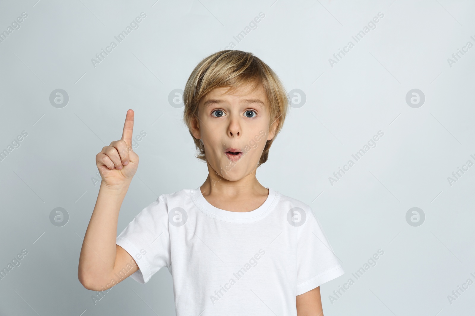 Photo of Emotional little boy on light grey background