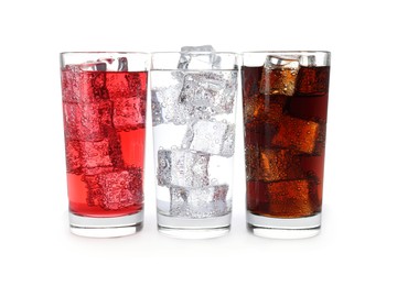 Photo of Glasses of different refreshing soda water with ice cubes isolated on white