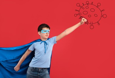 Teenage boy wearing superhero costume fighting against virus on red background