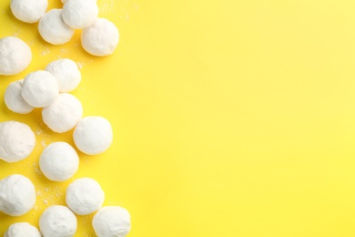 Photo of Snowballs on yellow background, flat lay. Space for text