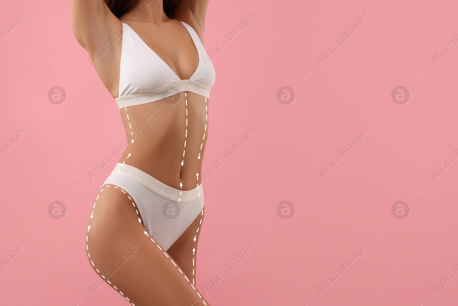 Image of Woman showing her beautiful figure on pink background, closeup. Space for text. Cosmetic treatment lines on her body