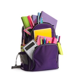 Purple backpack with different school supplies isolated on white
