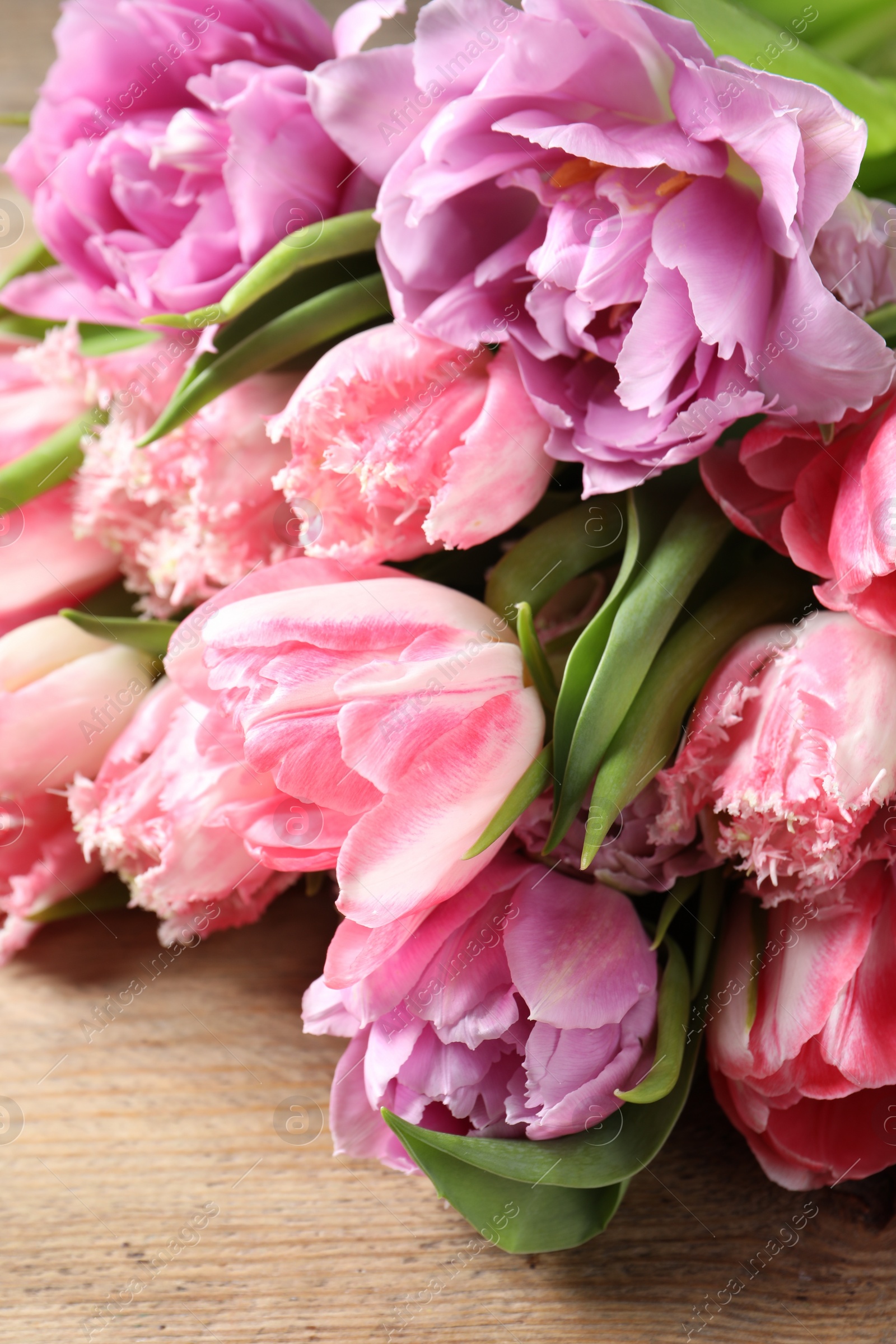 Photo of Beautiful bouquet of colorful tulip flowers on table, closeup