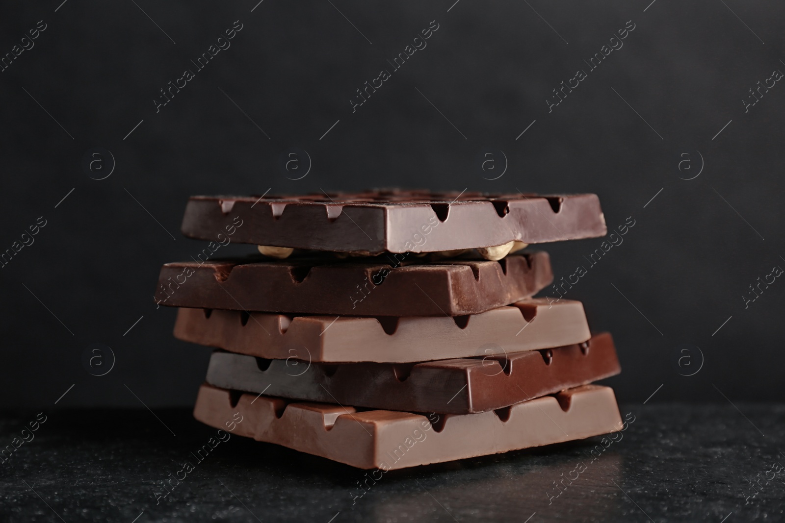 Photo of Delicious milk and dark chocolate bars on table