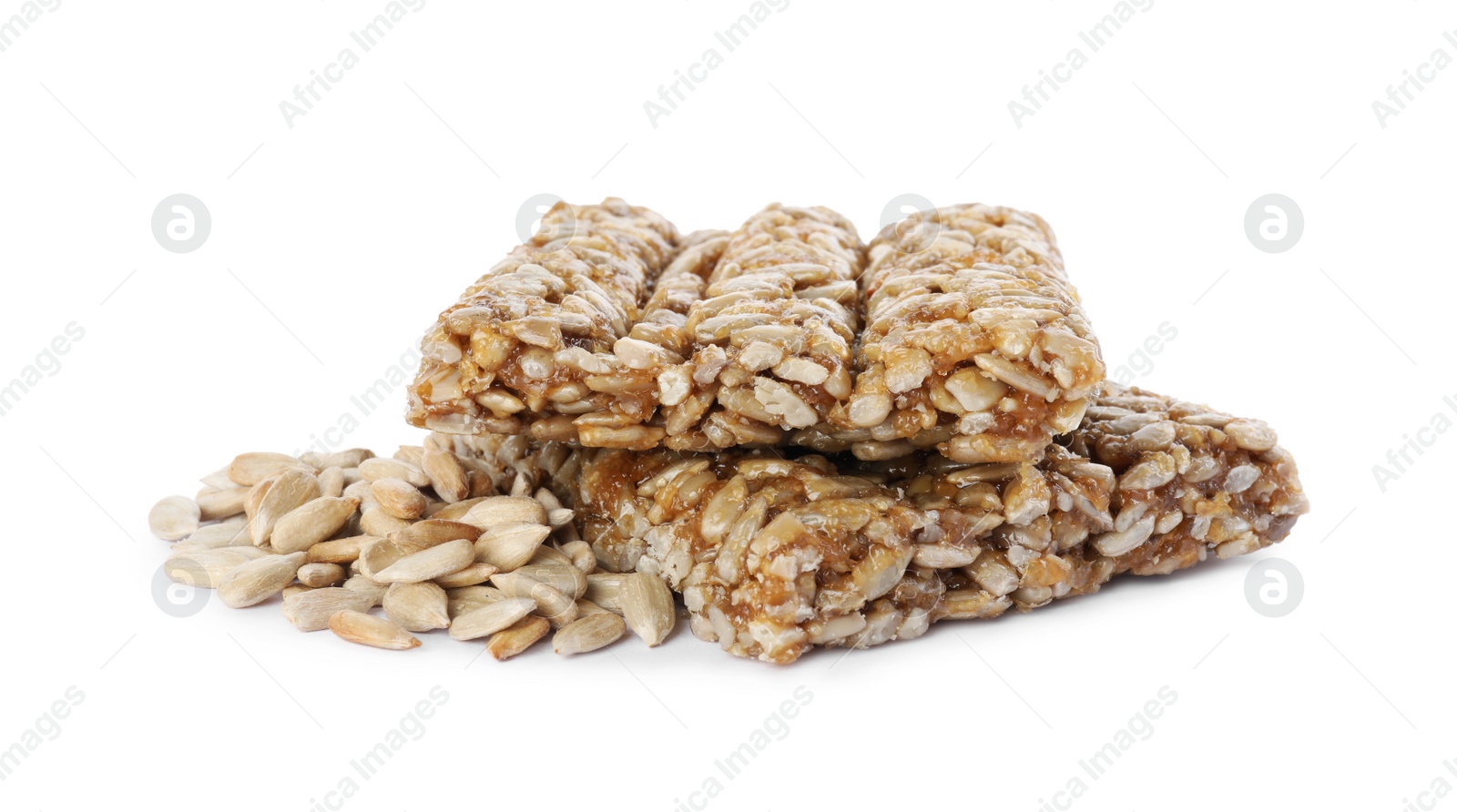 Photo of Delicious sweet kozinaki bars and sunflower seeds on white background