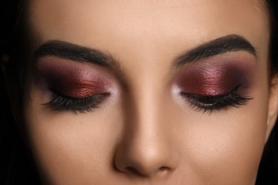 Photo of Young woman with evening makeup, closeup. Eye shadow product