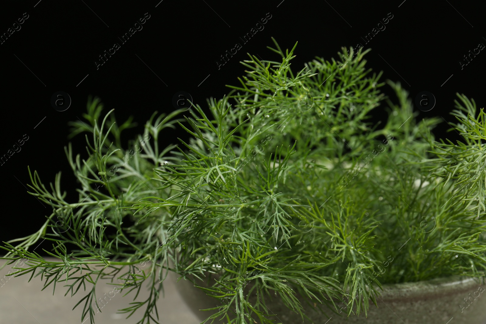 Photo of Fresh green dill in bowl on table, closeup
