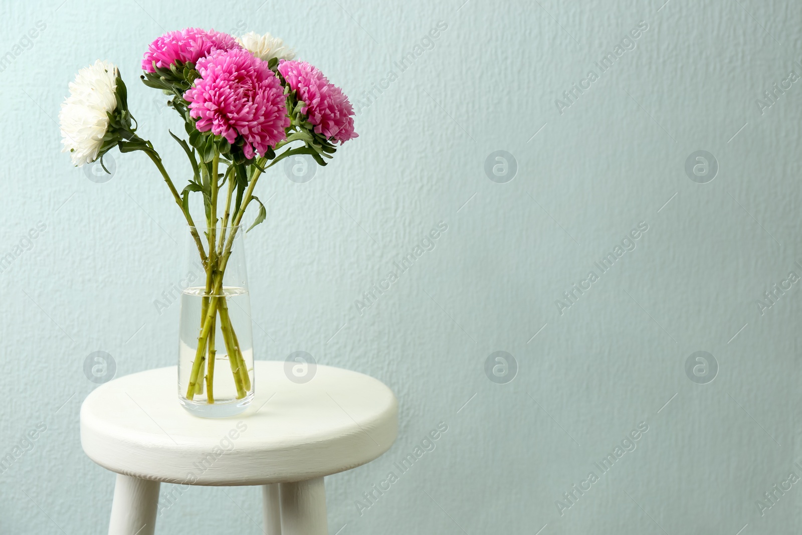 Photo of Bouquet of beautiful asters on table, space for text. Autumn flowers