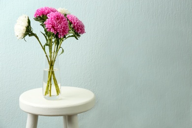 Bouquet of beautiful asters on table, space for text. Autumn flowers