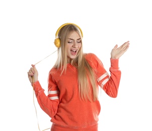 Beautiful young woman listening to music with headphones on white background