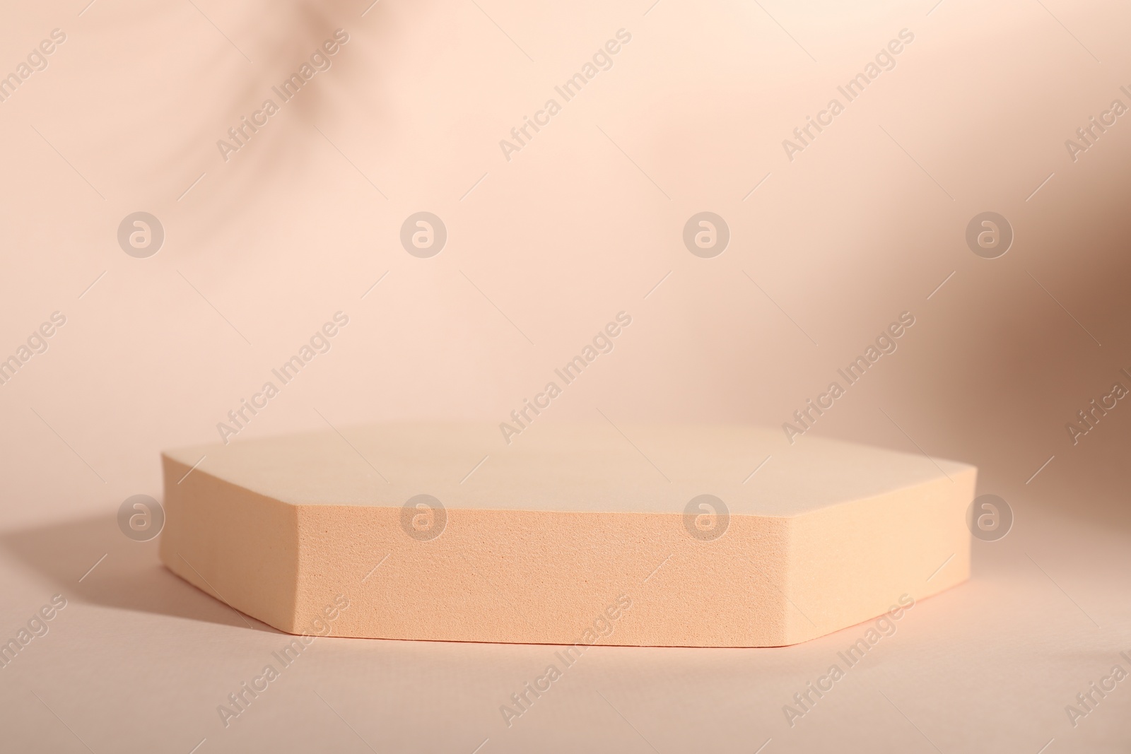 Photo of Presentation of product. Podium and shadows on pink background. Space for text