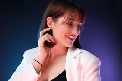 Photo of Portrait of happy woman on dark background