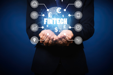 Image of Fintech concept. Man demonstrating world globe and different icons, closeup