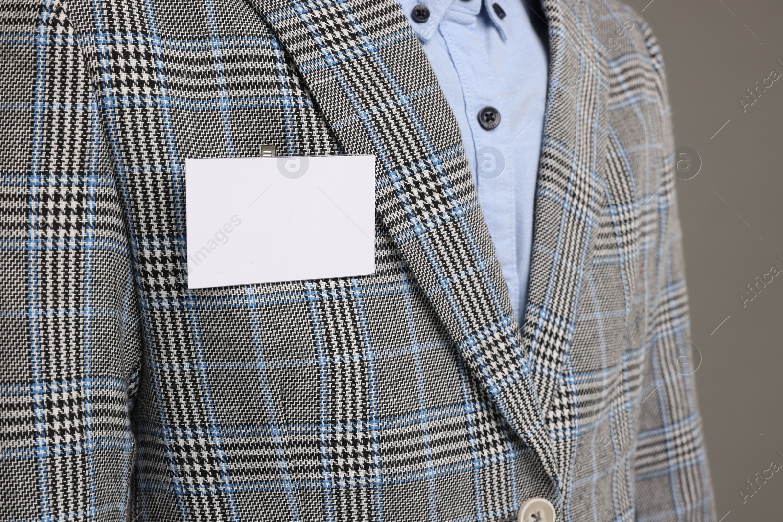 Photo of Man with blank badge on grey background, closeup