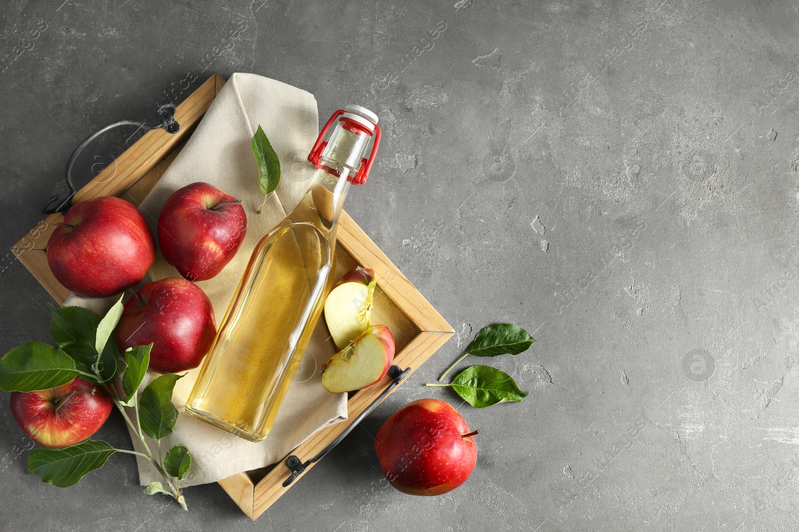 Photo of Flat lay composition with delicious apple cider on gray table, space for text