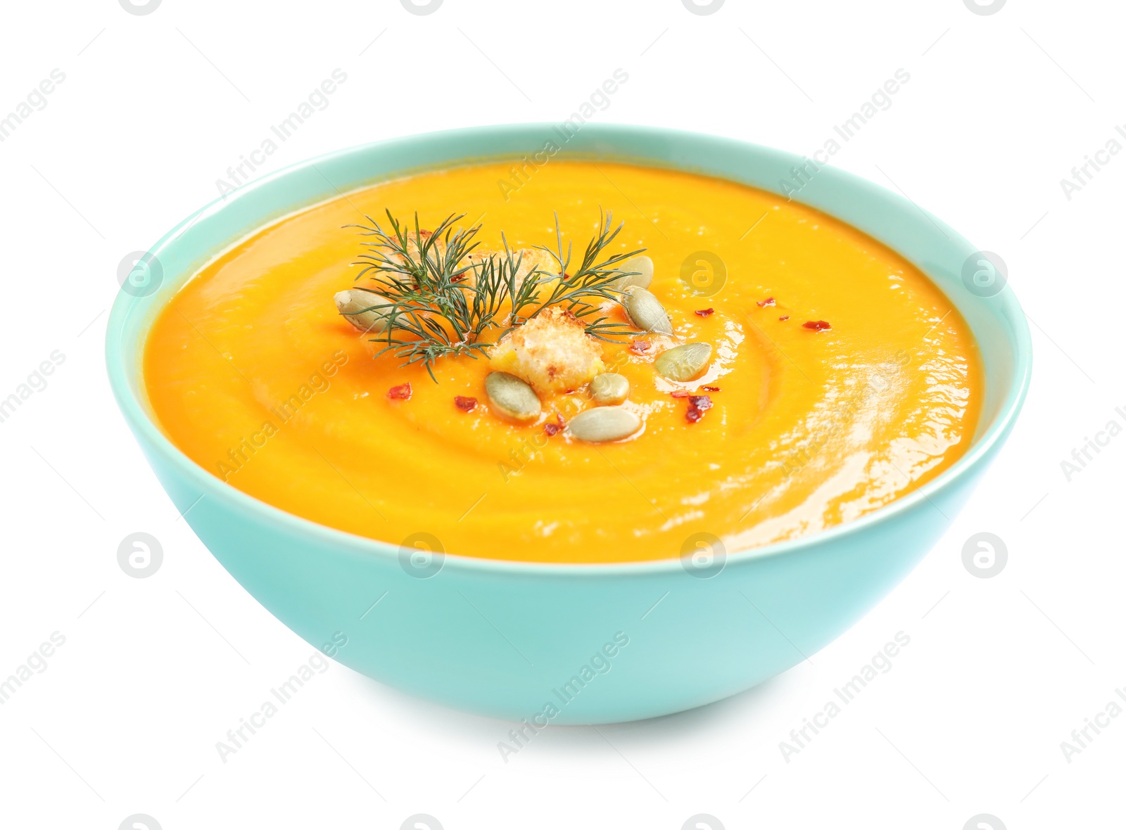 Image of Tasty creamy pumpkin soup in bowl on white background