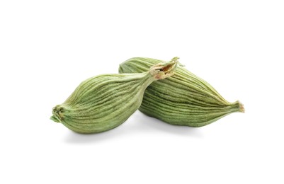 Photo of Dry green cardamom pods on white background, closeup