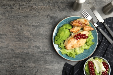 Tasty cooked chicken fillet and vegetables served on grey table, flat lay with space for text. Healthy meals from air fryer