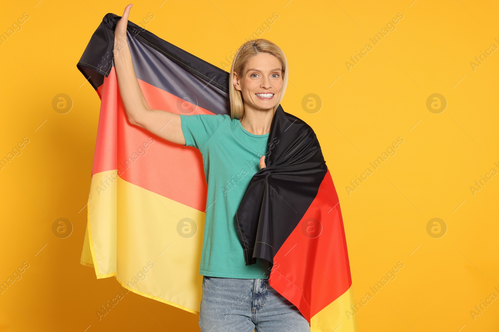 Photo of Woman with flag of Germany on yellow background