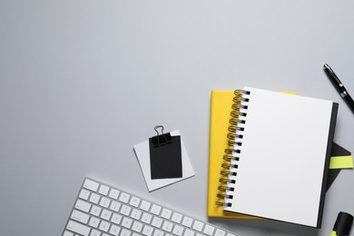 Photo of Flat lay composition with stylish notebooks on light grey table, space for text
