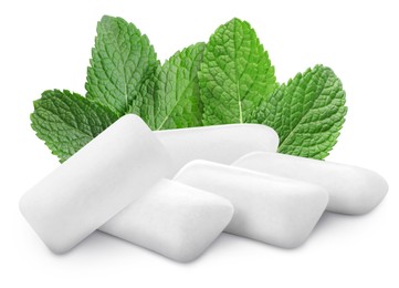 Menthol chewing gum pillows and mint leaves on white background