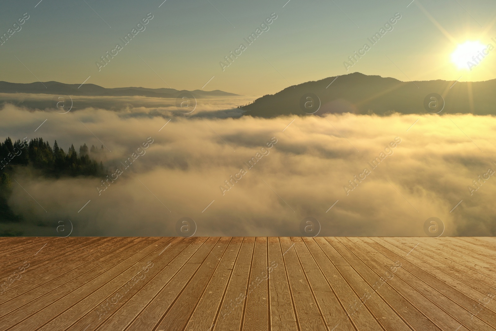 Image of Empty wooden surface and beautiful landscape with thick mist and forest in mountains