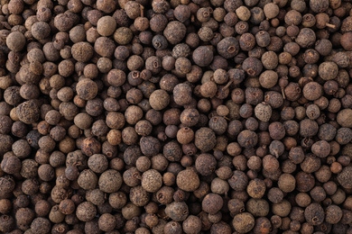 Photo of Black pepper grains as background, top view