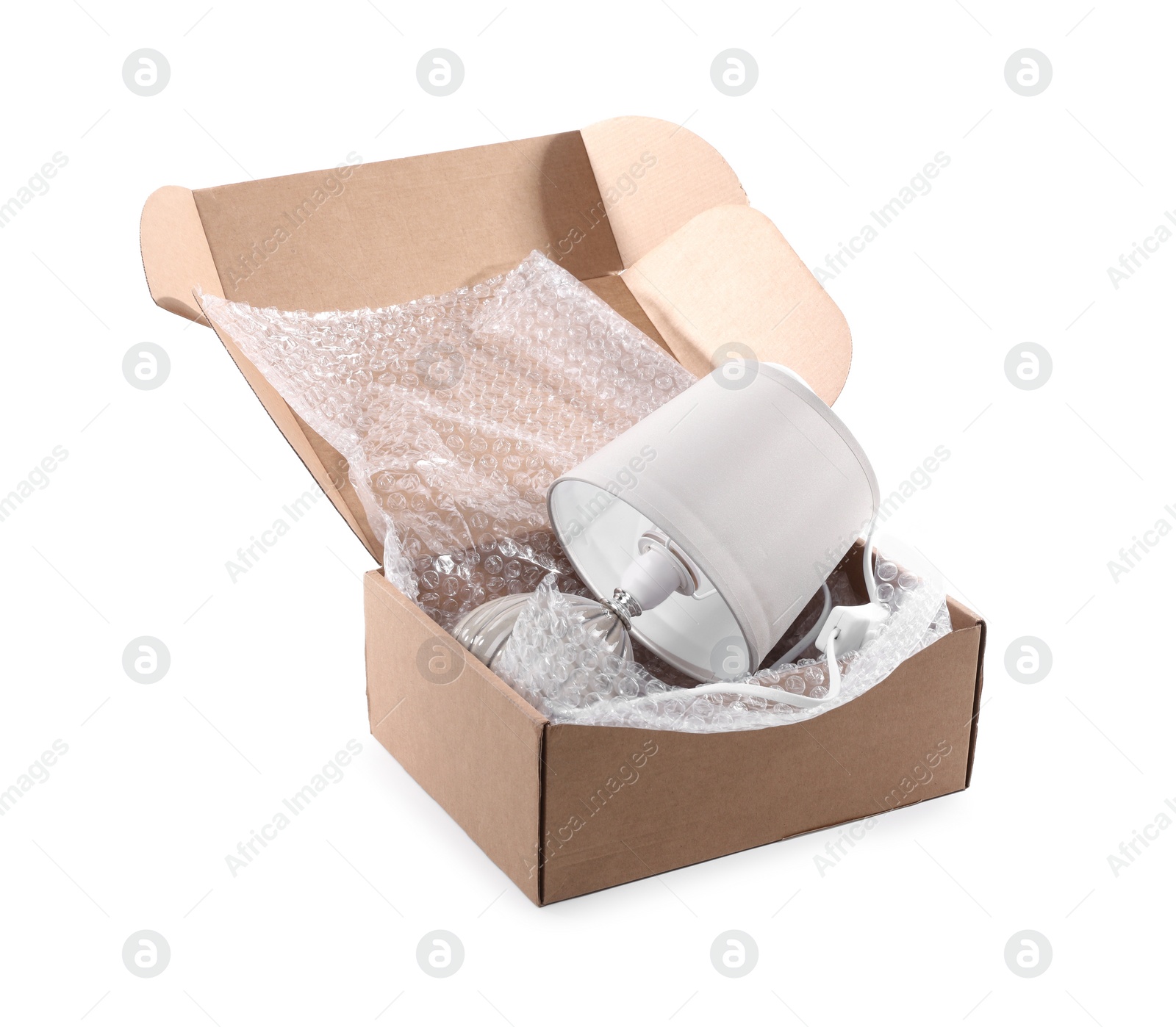 Photo of Lamp with bubble wrap in cardboard box isolated on white