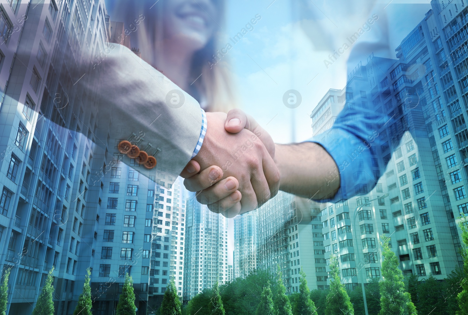 Image of Deal or partnership concept. Double exposure with cityscape and photo of businesspeople shaking hands