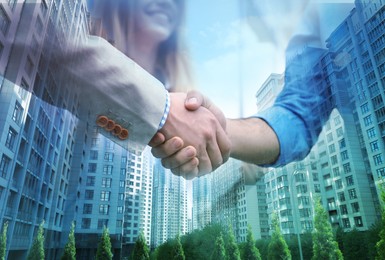 Image of Deal or partnership concept. Double exposure with cityscape and photo of businesspeople shaking hands