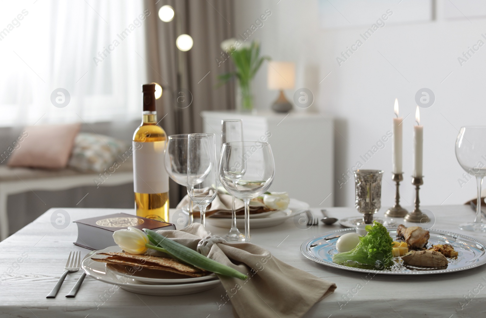 Photo of Festive Passover table setting with Torah at home. Pesach celebration