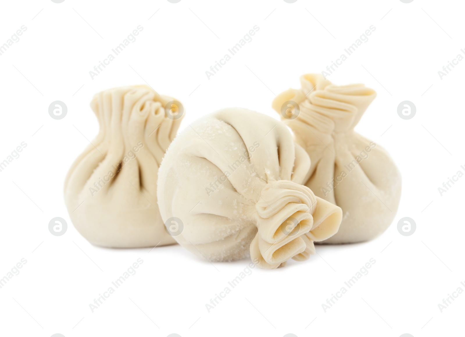 Photo of Raw dumplings with tasty filling on white background