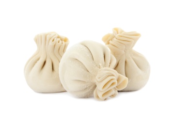 Photo of Raw dumplings with tasty filling on white background