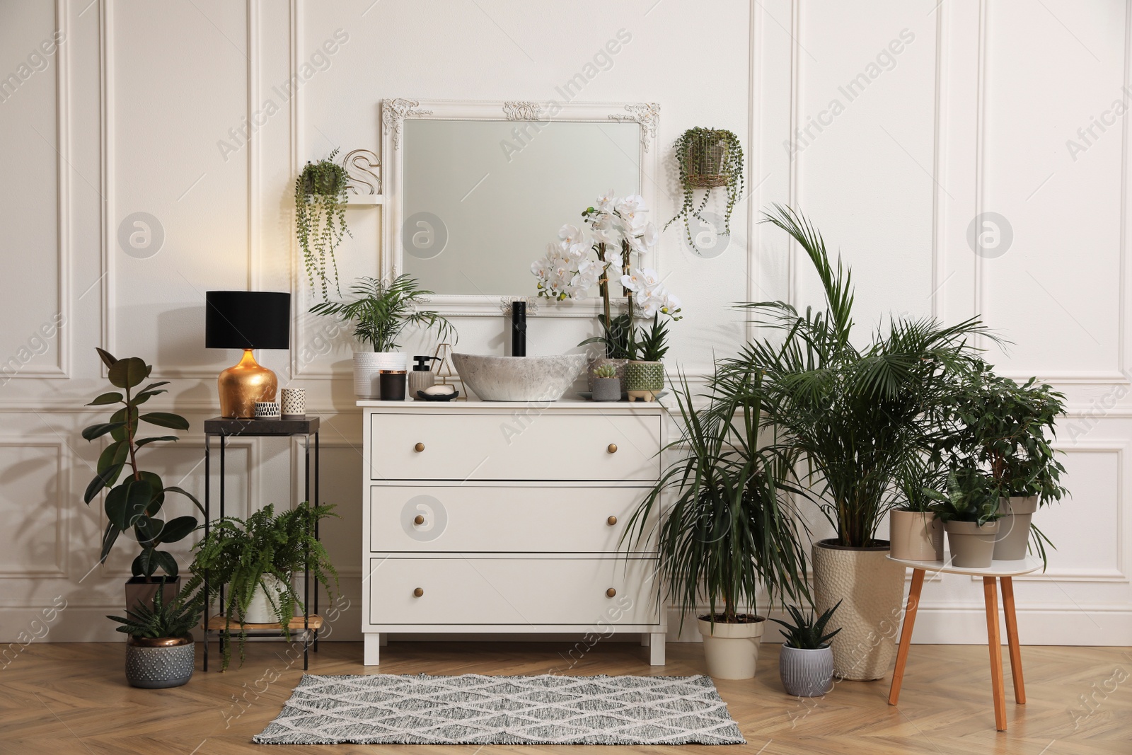 Photo of Stylish bathroom interior with modern furniture and beautiful houseplants