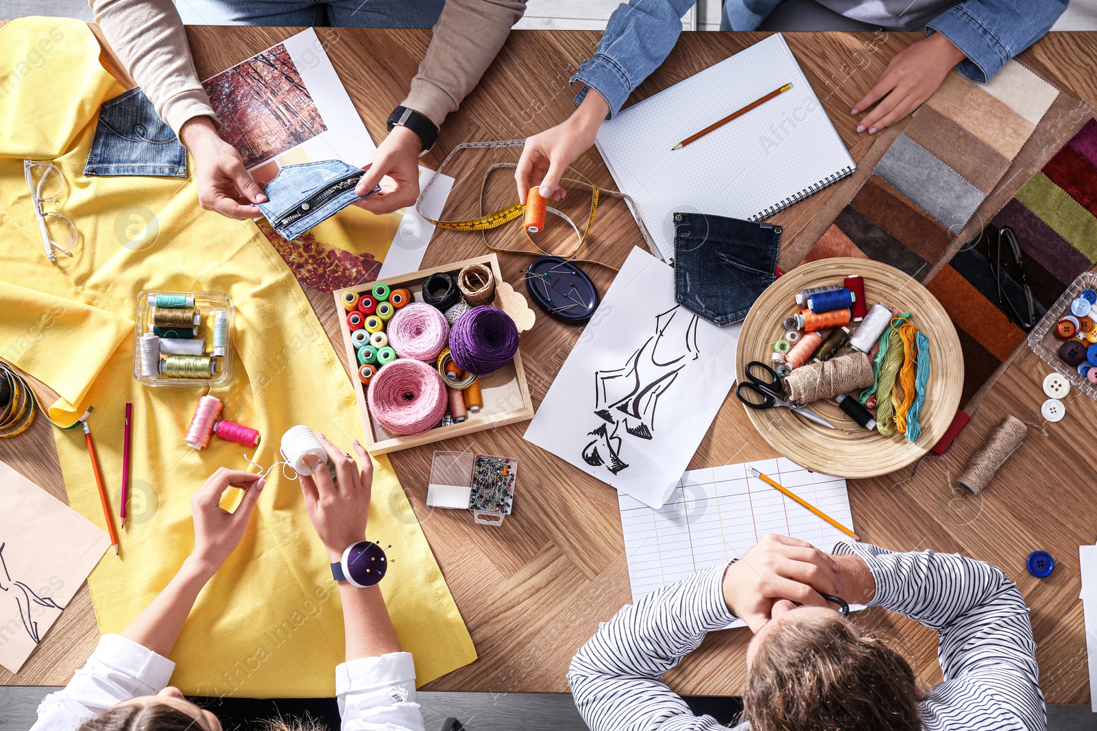 Photo of Fashion designer creating new clothes in studio, top view