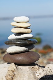 Photo of Stack of stones on rock near sea. Harmony and balance concept