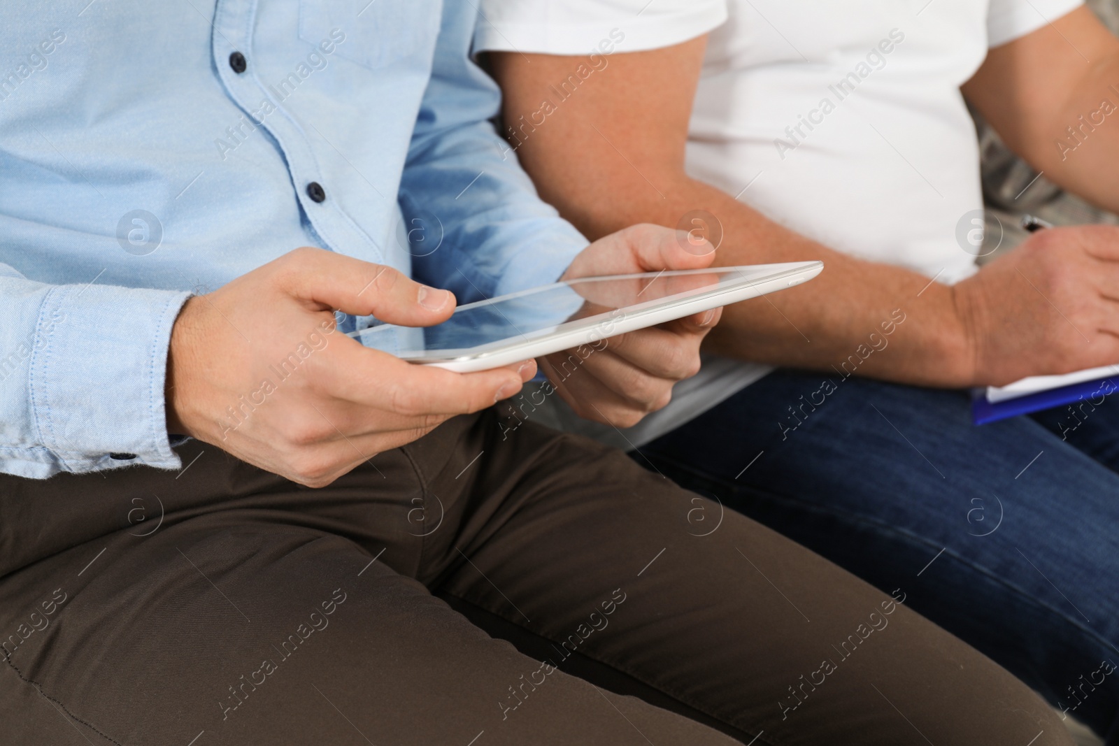 Photo of Man with tablet waiting for job interview in office, closeup