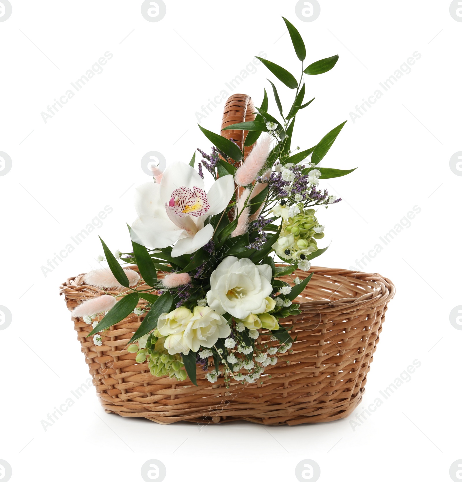 Photo of Wicker basket decorated with beautiful flowers on white background. Easter item