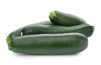 Fresh ripe green zucchinis on white background