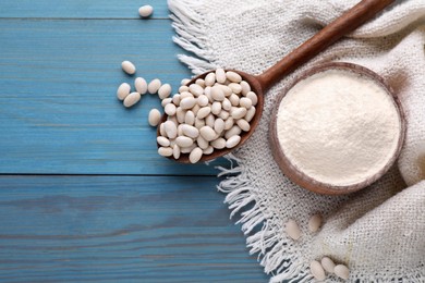 Photo of Kidney bean flour and seeds on light blue wooden table, flat lay. Space for text