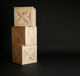 Photo of Group of wooden crates on black background