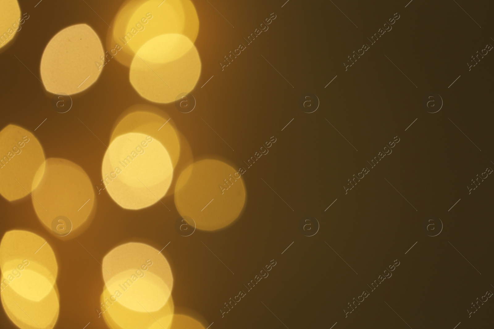 Photo of Blurred view of beautiful lights on color background, space for text