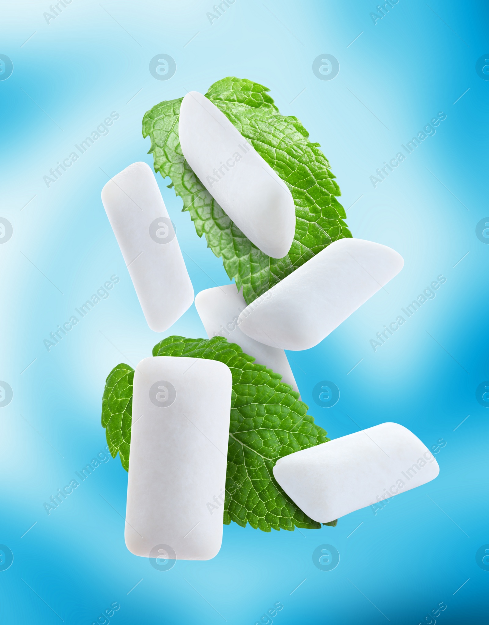 Image of Fresh mint leaves and chewing gum pads falling on light blue background